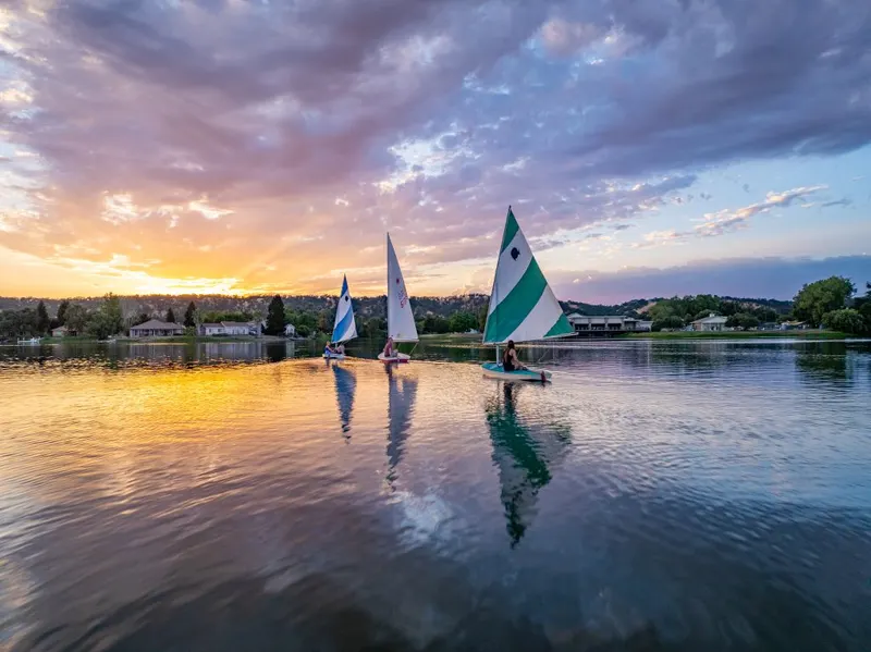 Sailing on a lake with 3 sailboats